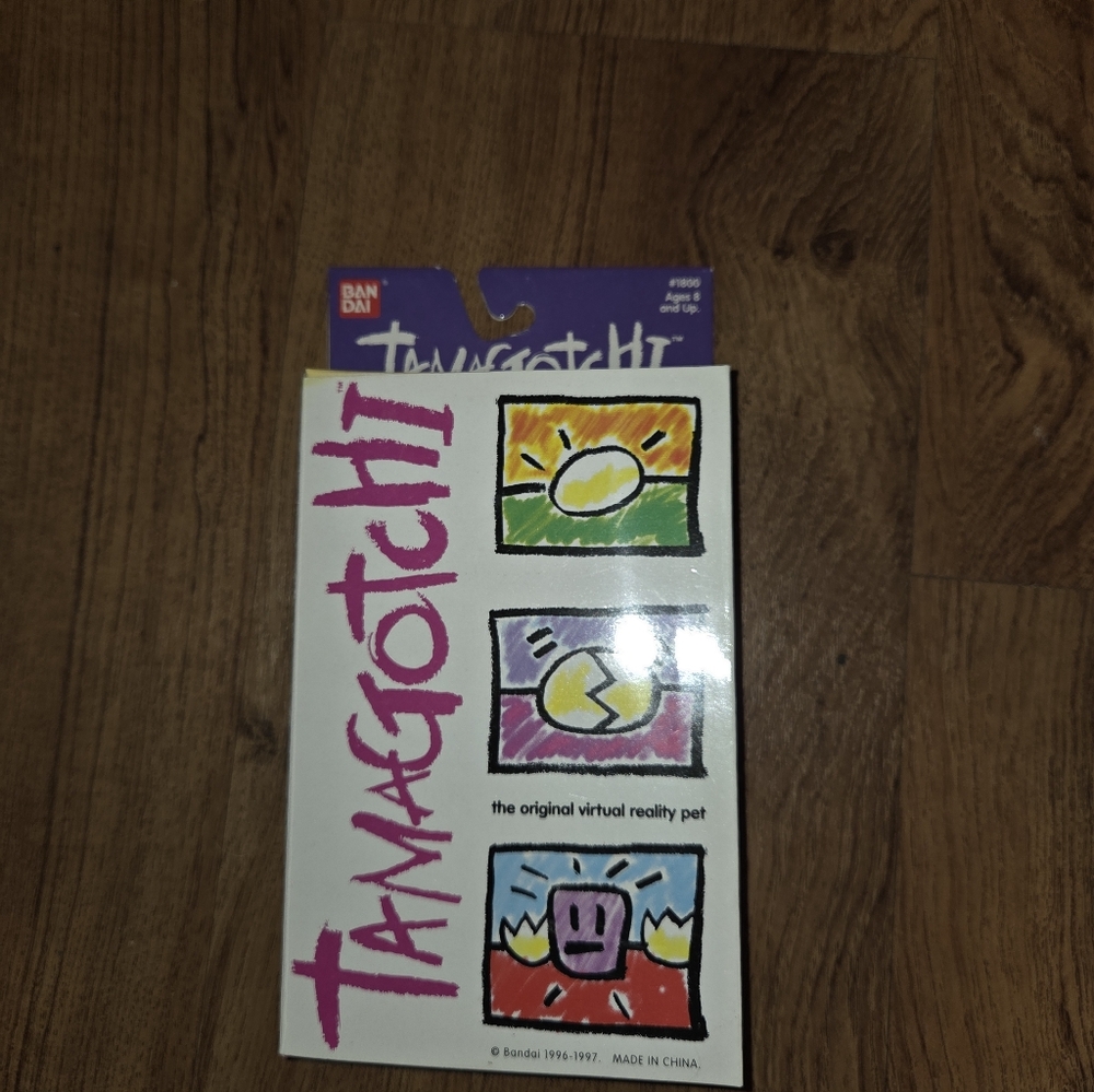 1996-97 Bandai Tamagotchi Virtual Reality Pet #1800 Red w/Yellow Buttons NOS - Picture 2 of 4